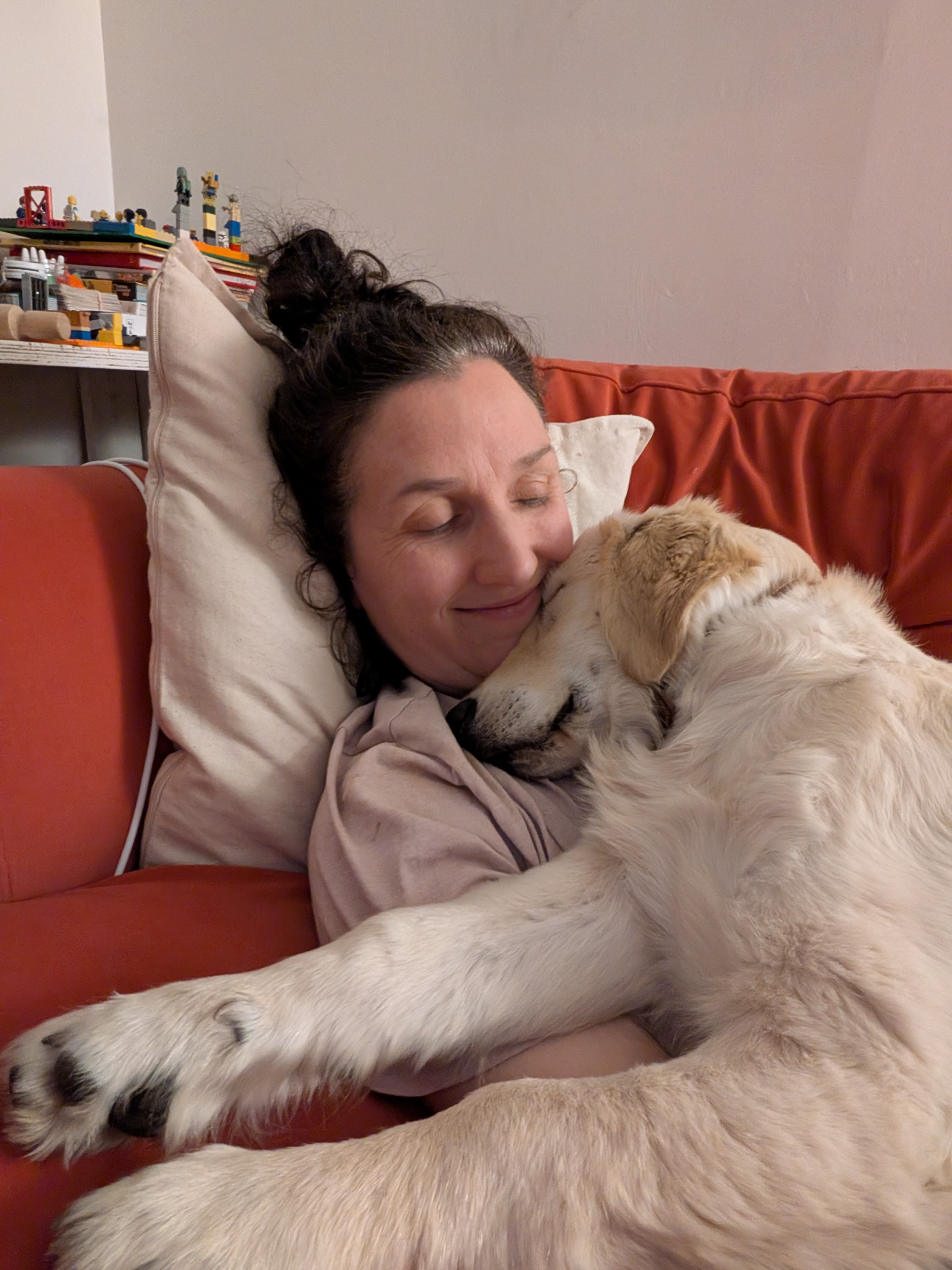 Impi cuddling a dog at home